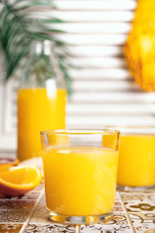 Preview: Fresh orange juice on table with slices fruits.