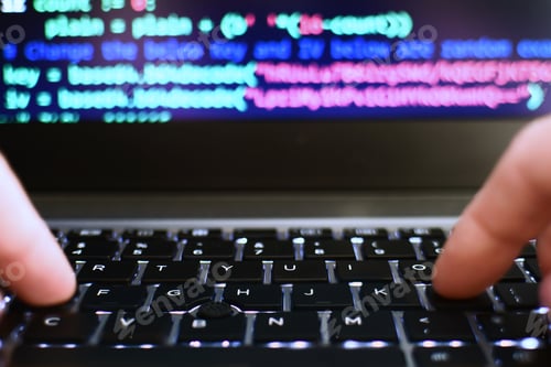 Preview: Programmer coder hacker typing on laptop computer keyboard, code on screen. Cyber security concept