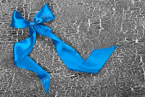 Preview: satin ribbon. Background grey, texture of cracked paint on old board. Copy space