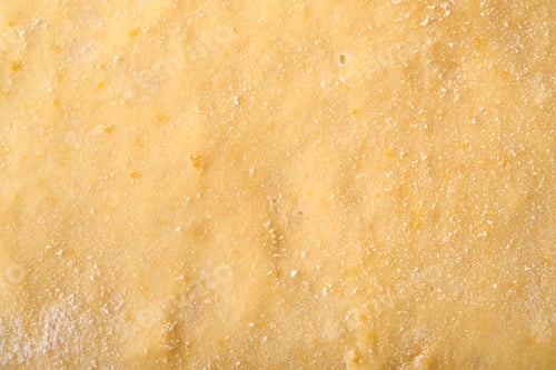 Preview: Raw yeast dough with pumpkin texture background. Concept home baking bread, buns or cinnabon or maki