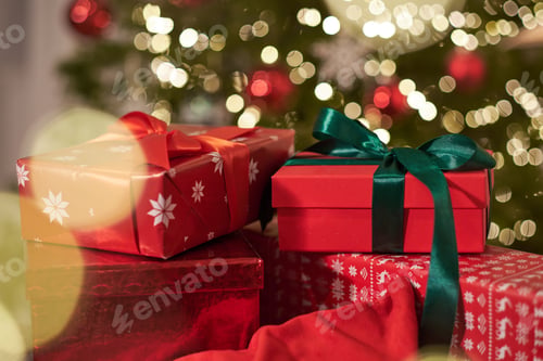 Preview: Pile of gifts on the background of a Christmas tree. Boxing day. Festive atmosphere.