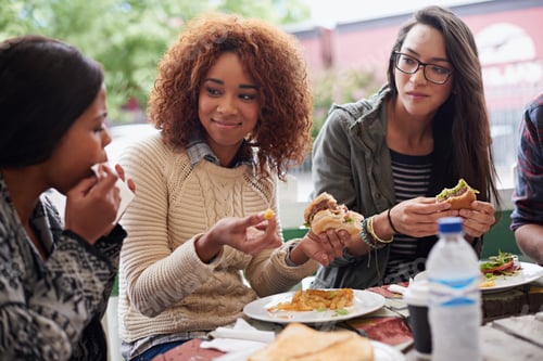 Preview: This is the best place in town. Cropped shot of a friends eating burgers outdoors.