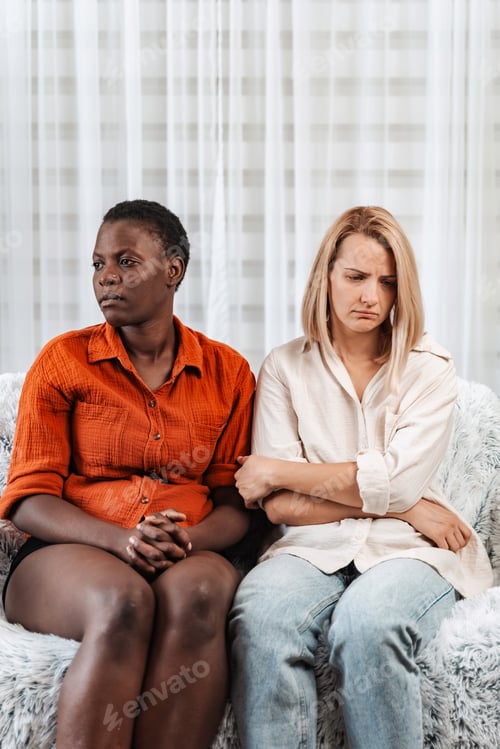 Preview: Two Young Women Feeling Sad and Disappointed on Sofa