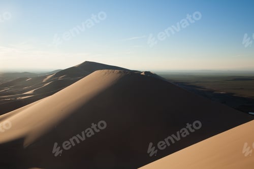 Preview: Serene sand dunes under a clear blue sky.