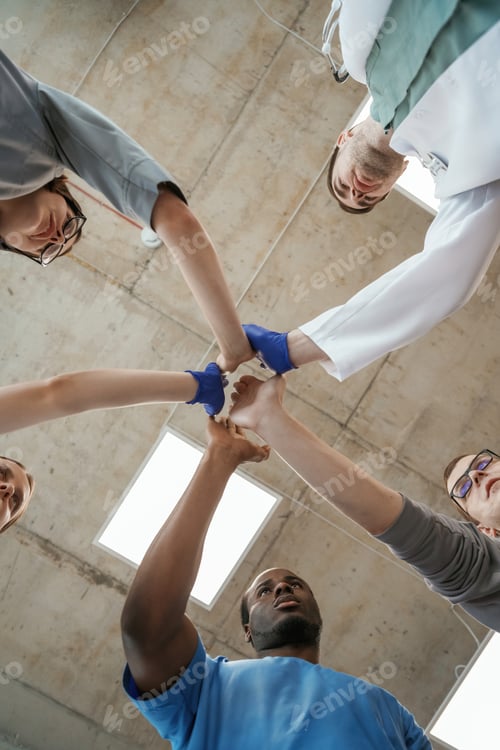 Preview: Celebrating success, hands gestures. View from below of group of doctors