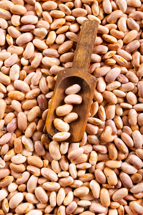 Preview: Beans and wooden spoon on a table, copy spase