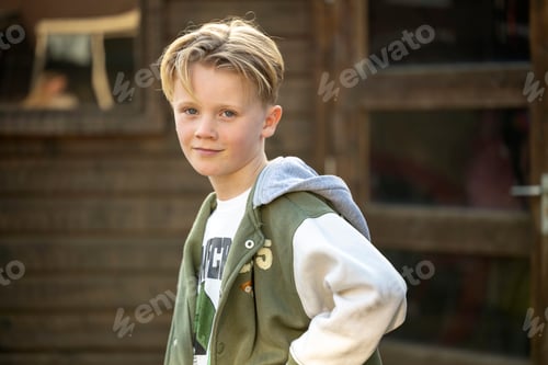 Preview: Boy with blonde hair smiling outdoors