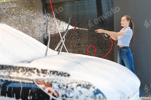 Preview: Woman washing car with soap and pressure washer