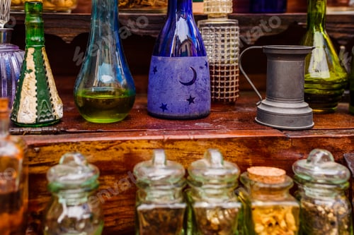 Preview: Antique glass jars with spices and perfumes on a vintage retro shelf.
