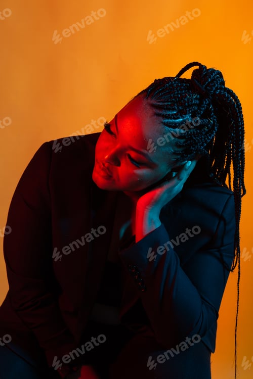 Preview: Beautiful young African woman posing against a dark background