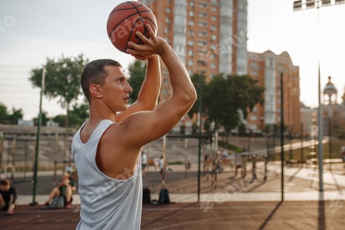 Preview: Basketball player makes a throw on outdoor court