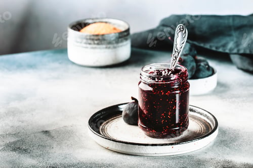 Preview: Fig jam in glass jar with fresh blue figs. Homemade preparations and canning