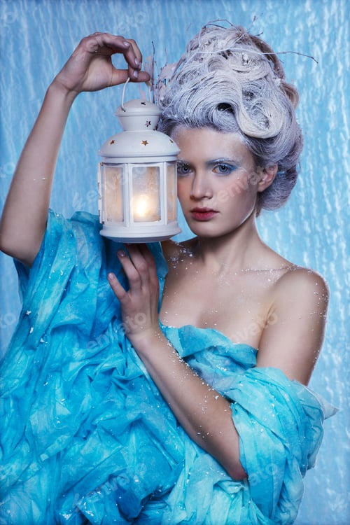 Preview: Fantasy Portrait Of Beautiful Young Woman Imaging Ice Fairy On Frozen Blue With Lantern