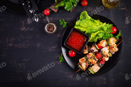 Preview: Grilled meat skewers, chicken shish kebab with zucchini, tomatoes and red onions.