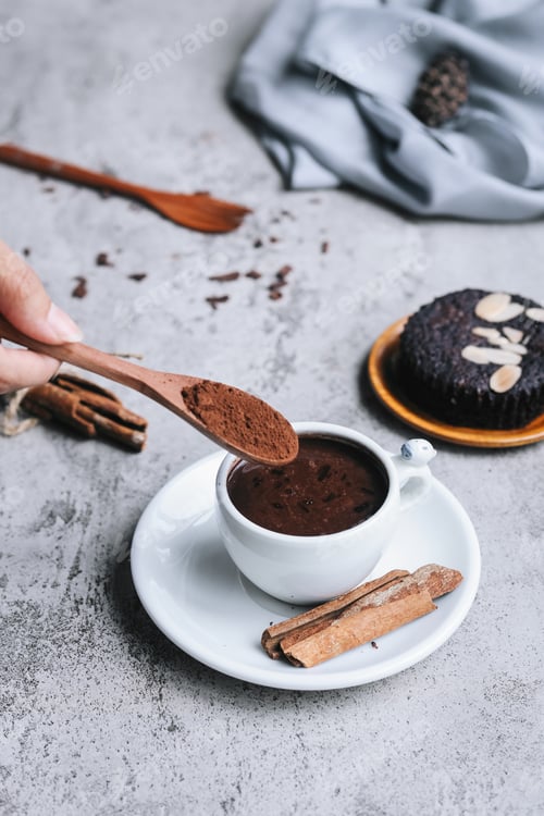 Preview: Pouring cocoa powder into hot drink