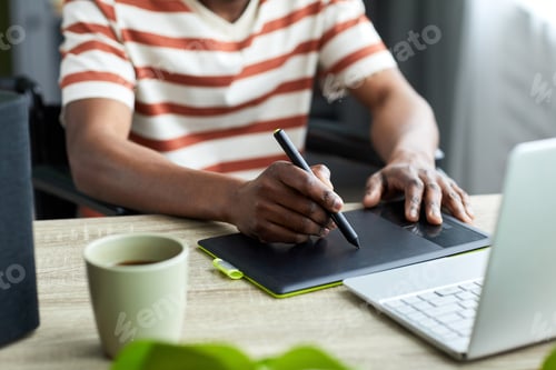 Preview: Man with Disability using Pen Tablet Closeup