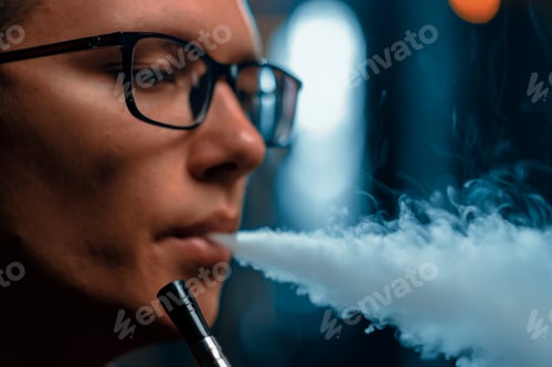 Preview: close-up Hookah man in glasses smoking a traditional hookah pipe Man exhaling smoke in a hookah