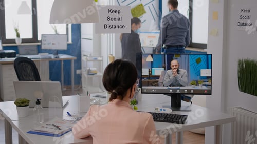 Preview: Freelancer sitting at desk table in new normal company office
