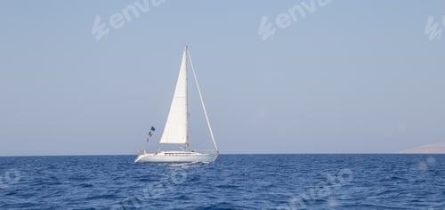 Preview: Single white sailboat on the sea under the beautiful blue sky