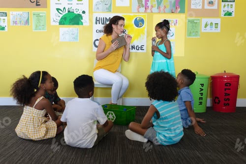 Preview: Caucasian young female teacher talking to african american girl during environment class