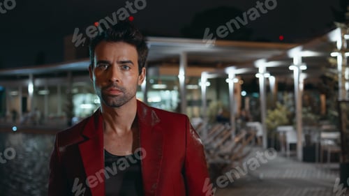 Preview: Brutal man relaxing night poolside club in red suit close up. Rich latin macho