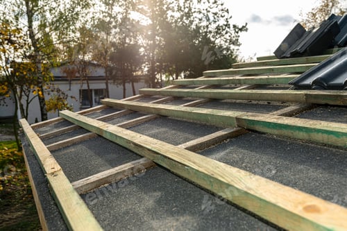 Preview: Roof ceramic tile arranged in packets on the roof on roof battens. laying tiles on a boarded roof.