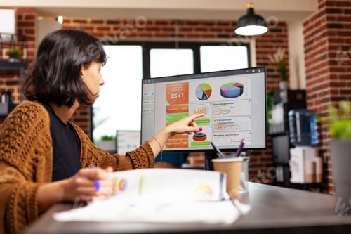 Preview: Entrepreneur analyzing management graph working at company strategy in startup office