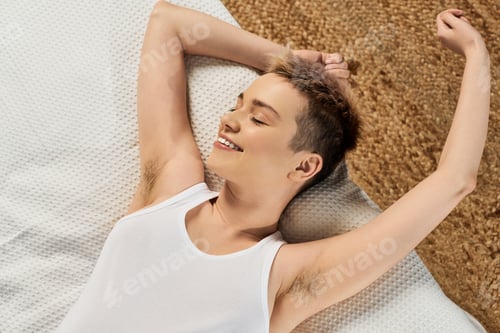 Smiling Woman Relaxing on a Comfortable Quilted Surface