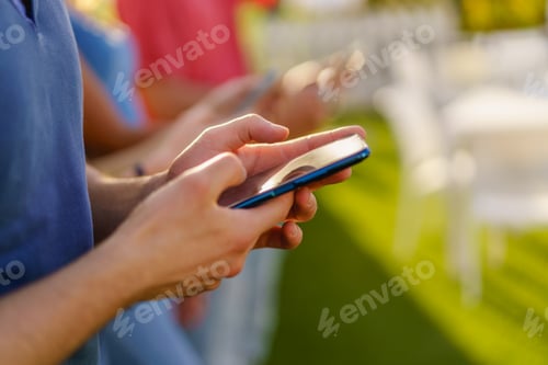 Preview: Closeup of hands using smartphones outdoors