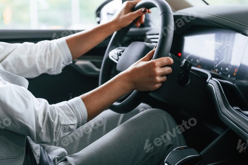 Preview: Modern quality interior. Woman is sitting in a car and driving it