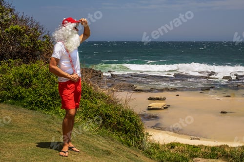 Preview: Santa Claus looking at the ocean view. Australia, Christmas in summer time.