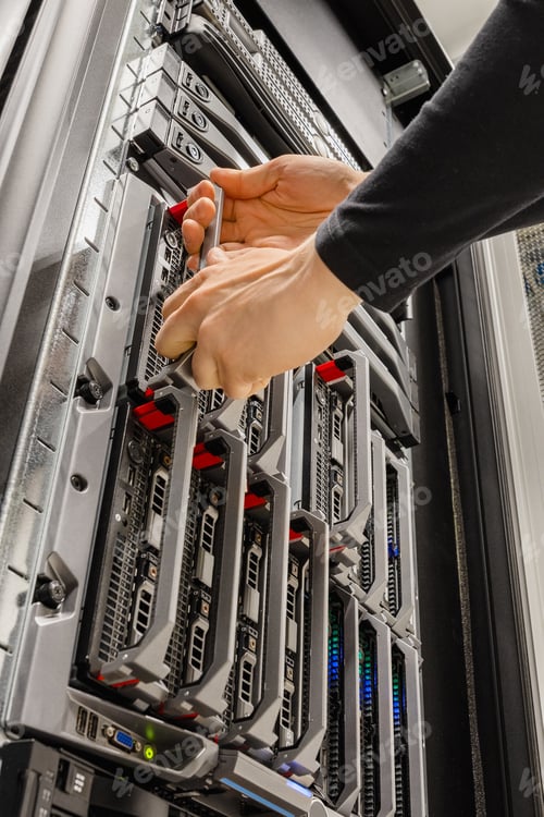 Preview: Male IT Consultant Removing Blade Server From Rack in Datacenter