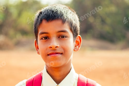 Preview: indian smart boy arms crossed looking at camera in backyard