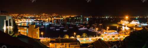 Preview: Panoramic night picture of Mindelo city in twilight. Port town with many boats in the lagoon on the