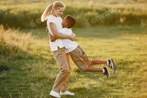 Preview: Multi-racial family playing in a summer park