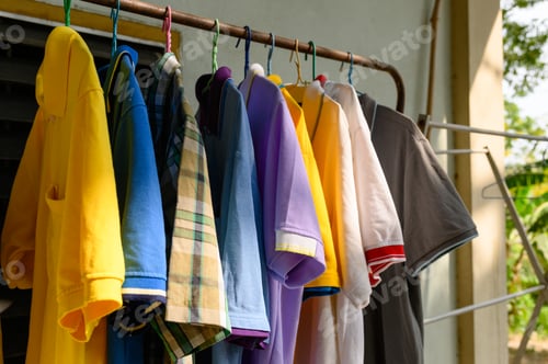 Preview: Colorful male shirt hanging on clothes line in sunny