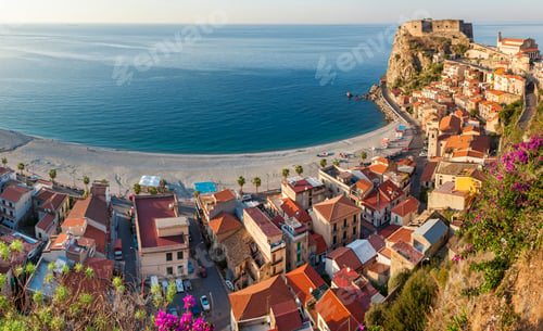 Preview: High angle view of seaside town with castle on cliff and sandy beach on the Mediterranean coast.