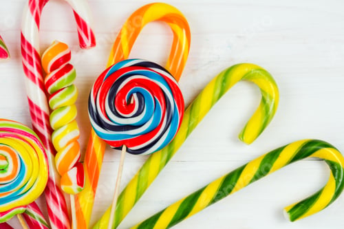 Preview: Colorful candy on white wooden background