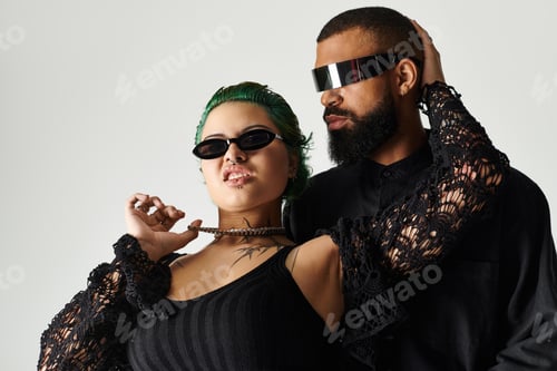 Preview: Chic multicultural couple poses confidently in trendy sunglasses during a shoot