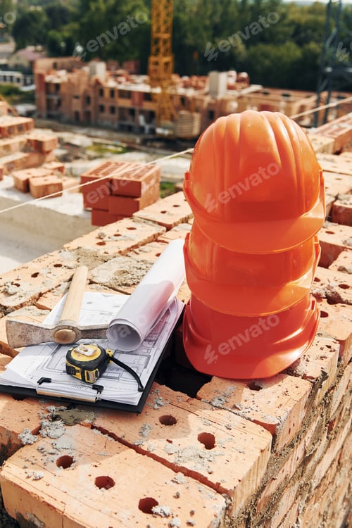 Preview: Close up view of protective hard hats that laying down on the bricks