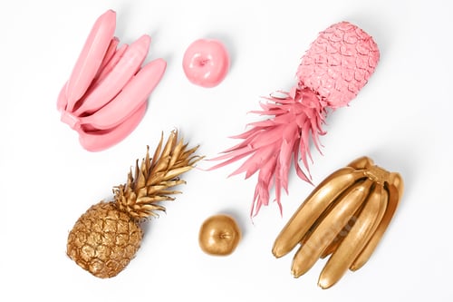 Preview: Composition with gold and pink fruits on white background, top view