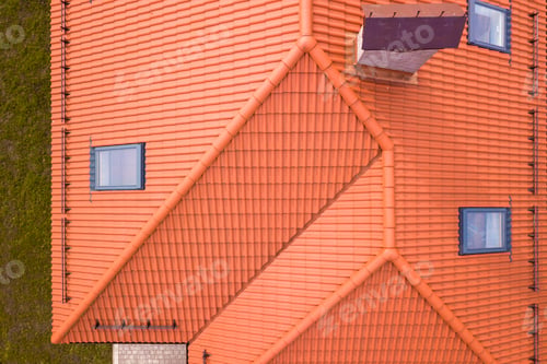 Preview: Aerial top view of house with metal shingle roof, brick chimneys and attic windows.