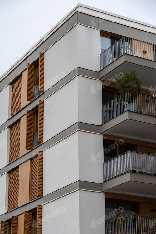 Preview: Exterior of a modern apartment complex with small balconies