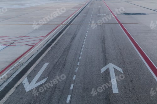 Preview: Arrow signs on road. taxiway for airplanes and tracks for road transport. Airport. Travel concept