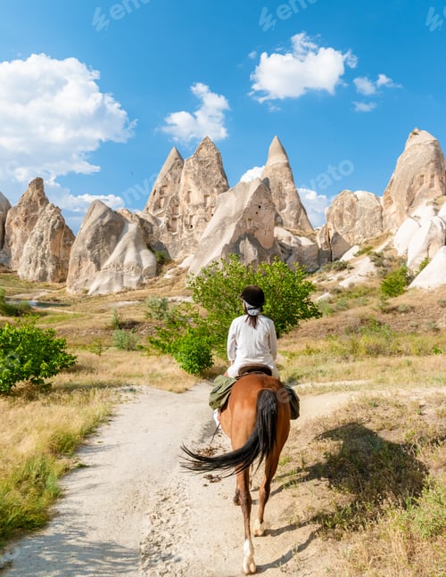 Preview: young woman during vacation in Turkey Kapadokya watching the hot air balloons of Cappadocia