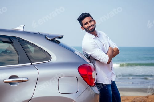 Preview: Indian businessman standing near car outdoors on sea beach summer good day