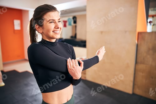 Preview: Joyful young woman having a proper warm-up