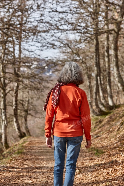 Preview: Woman walking in the woods. Healthy lifestyle. Natural environment