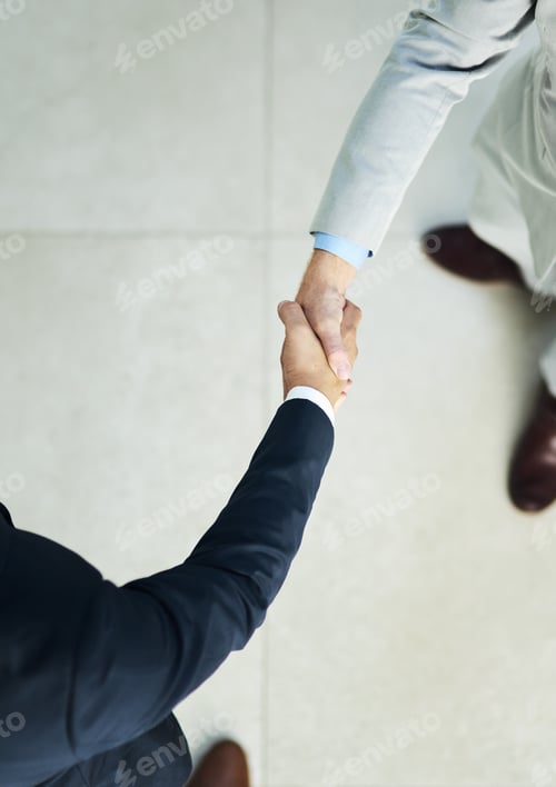 Preview: High angle shot of two unidentifiable businessmen shaking hands in the office