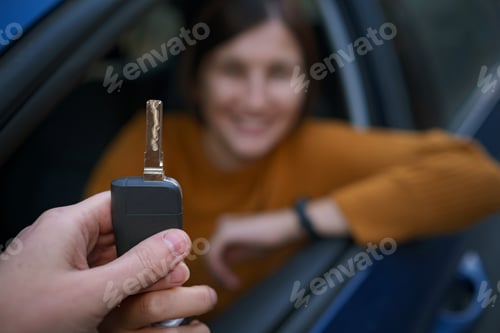 Preview: Auto Dealer Giving asian Woman Automobile Key For Test Drive.